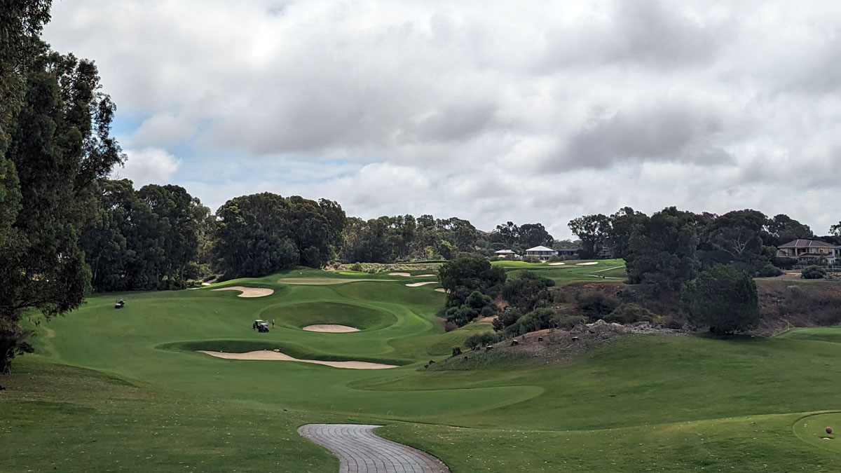 shot of a golf course with flowing fairways and trees